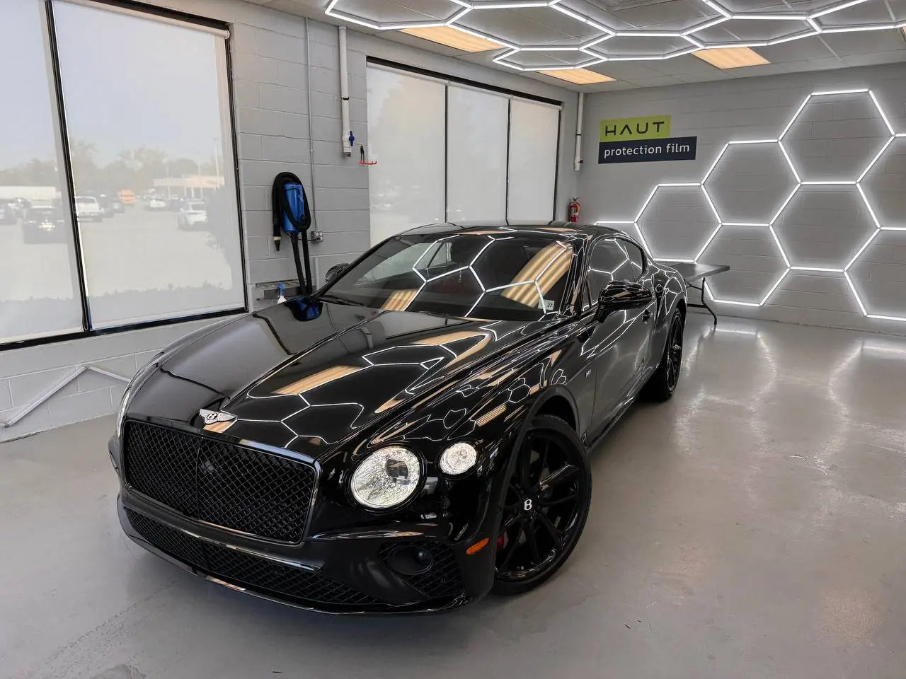 Black Bentley Continental GT in the install bay