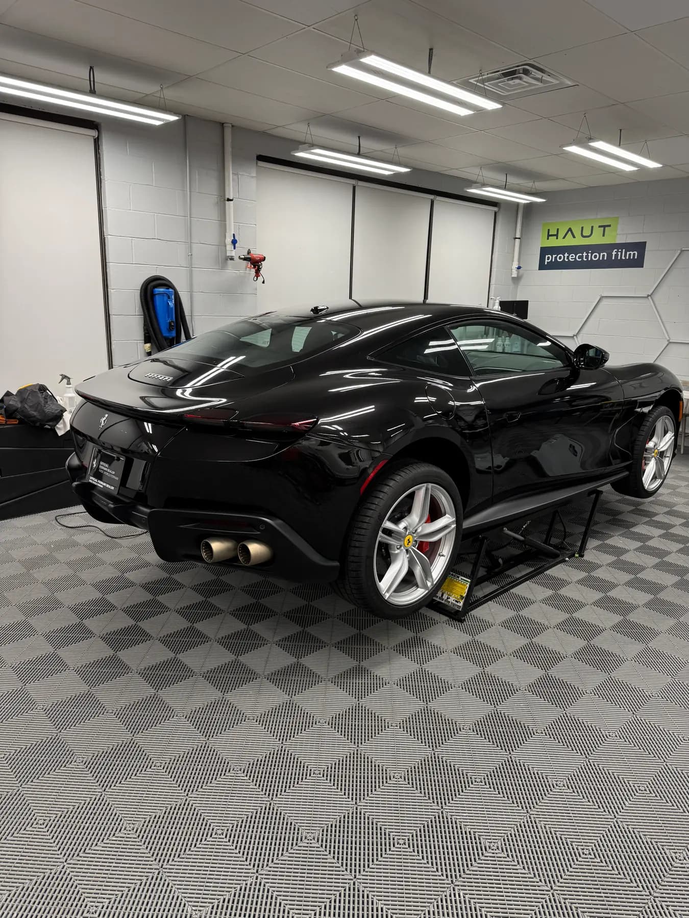 Black Ferrari Portofino finished and parked in the install bay