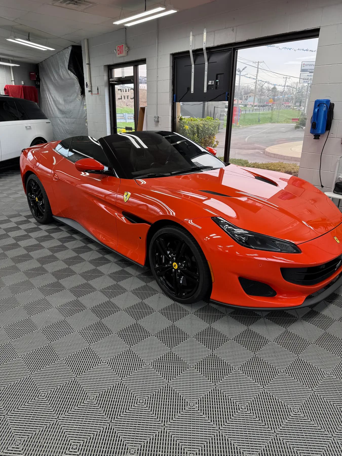 Orange Ferrari Portofino in the install bay