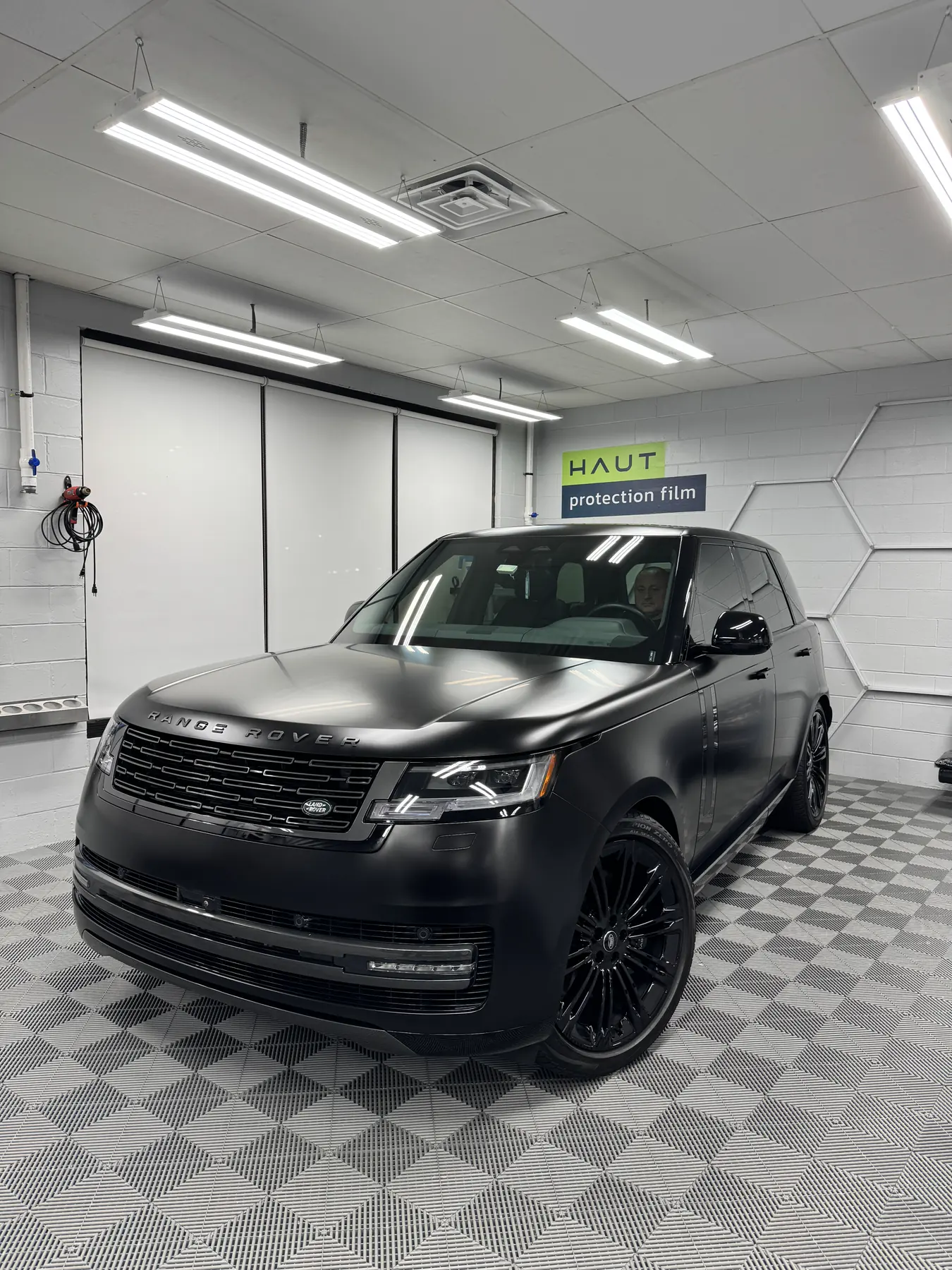 Matte black Range Rover in the install bay