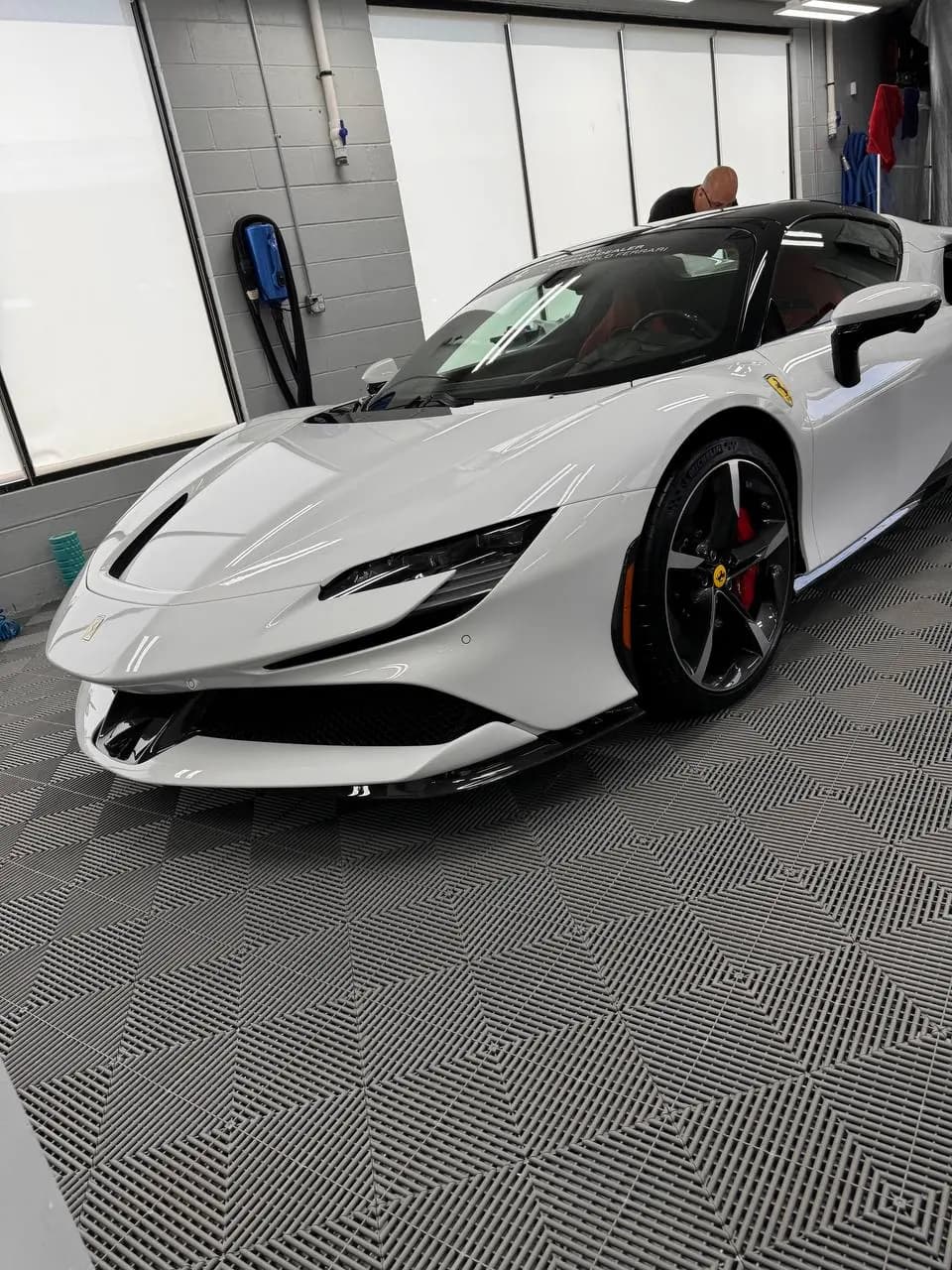 White Ferrari SF90 in the install bay