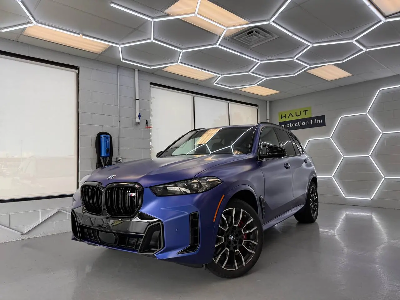 Blue BMW X6 M in the install bay