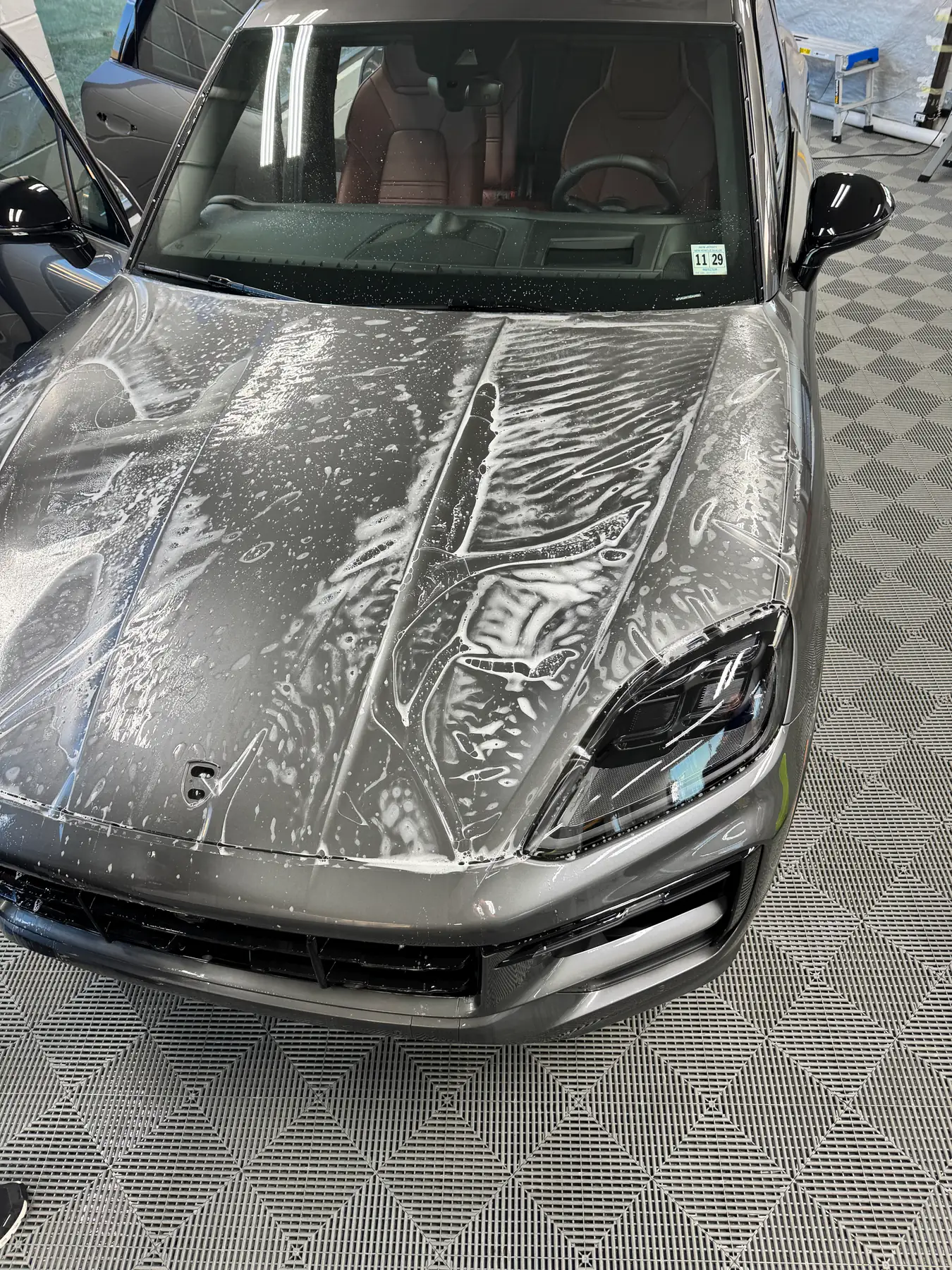 Paint protection film squeegeed across the bonnet of a Porsche Cayenne