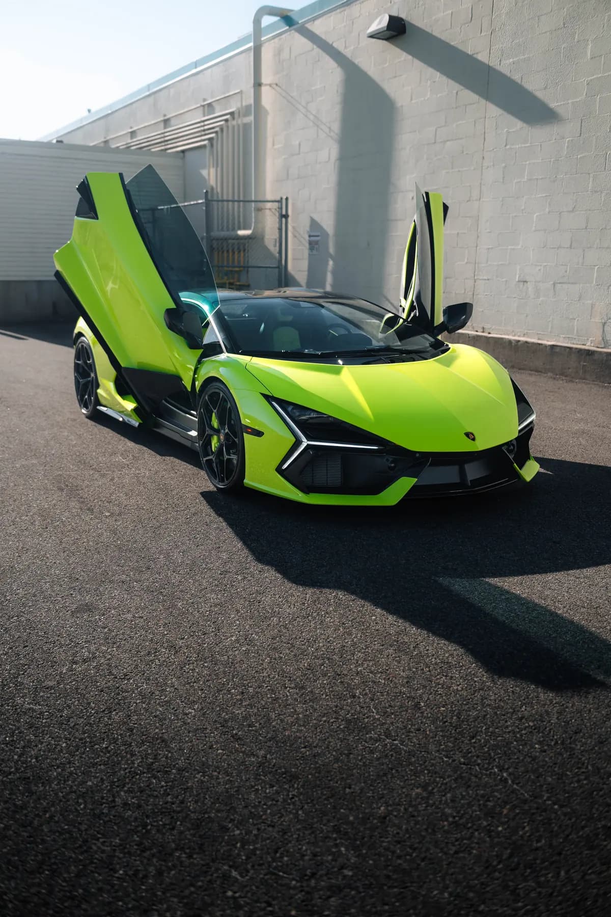 Lime Lamborghini Revuelto with both scissor doors open