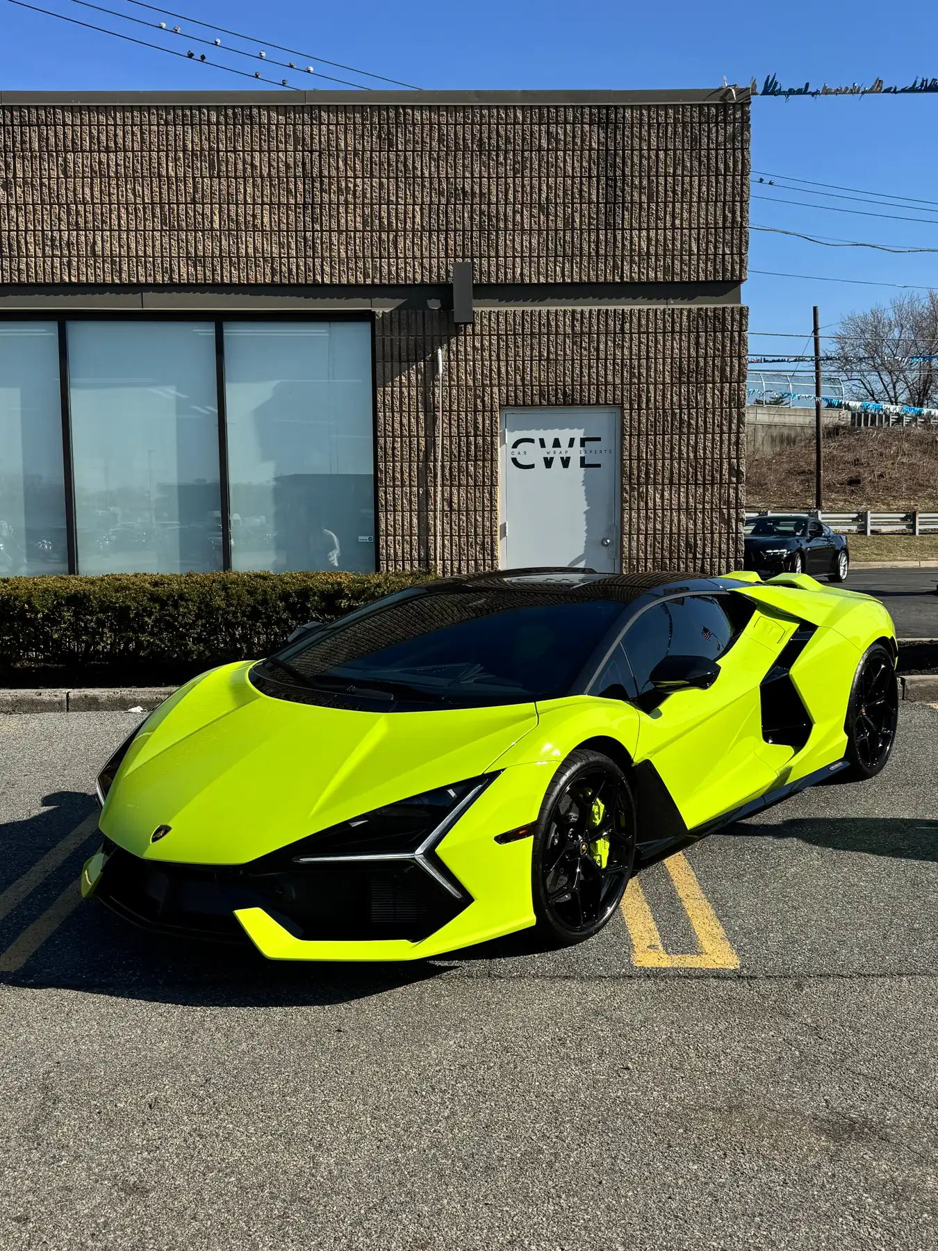 Lime Lamborghini Revuelto parked outside the HAUT installation shop