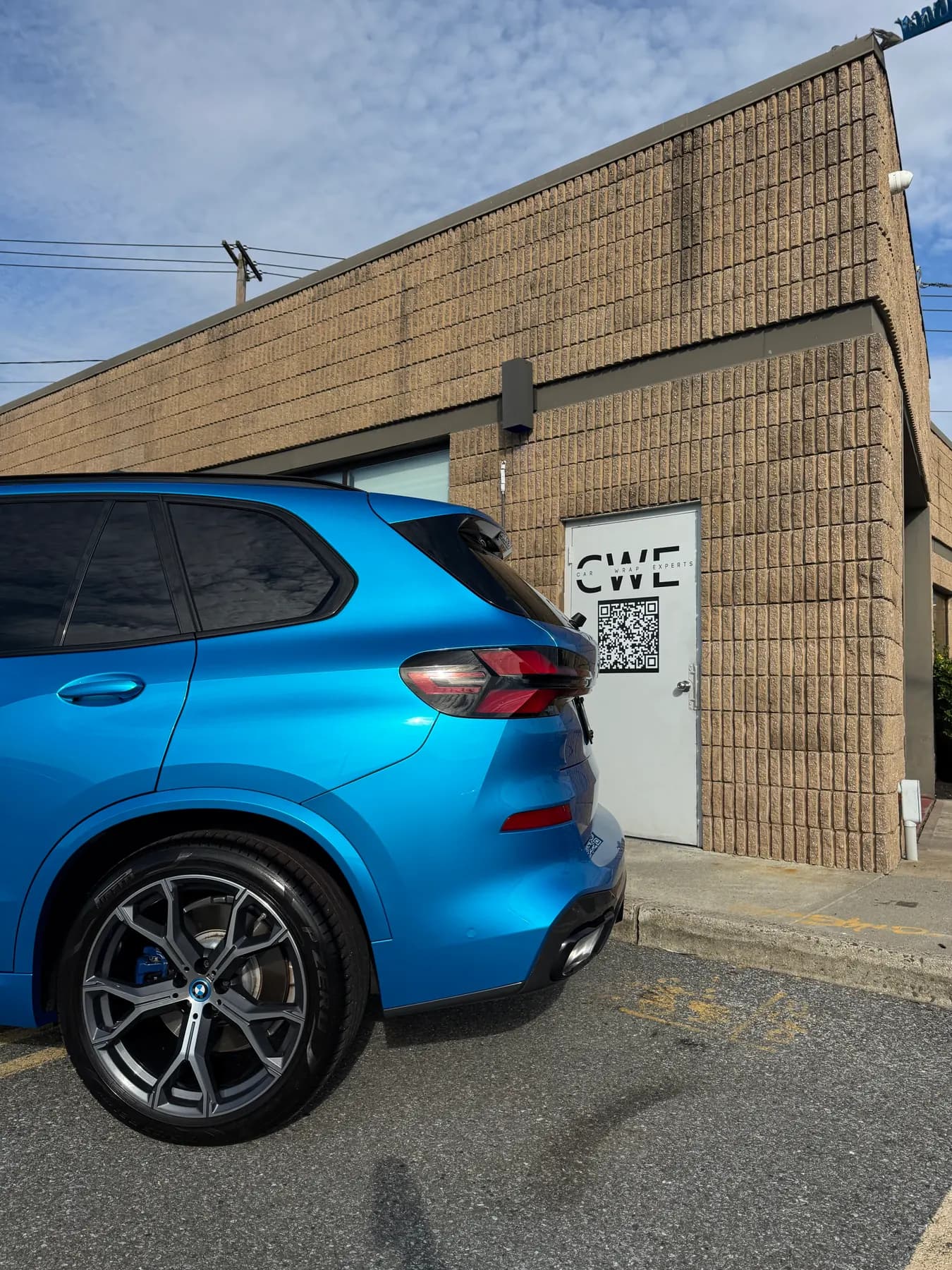 Blue BMW X5 parked outside the shop