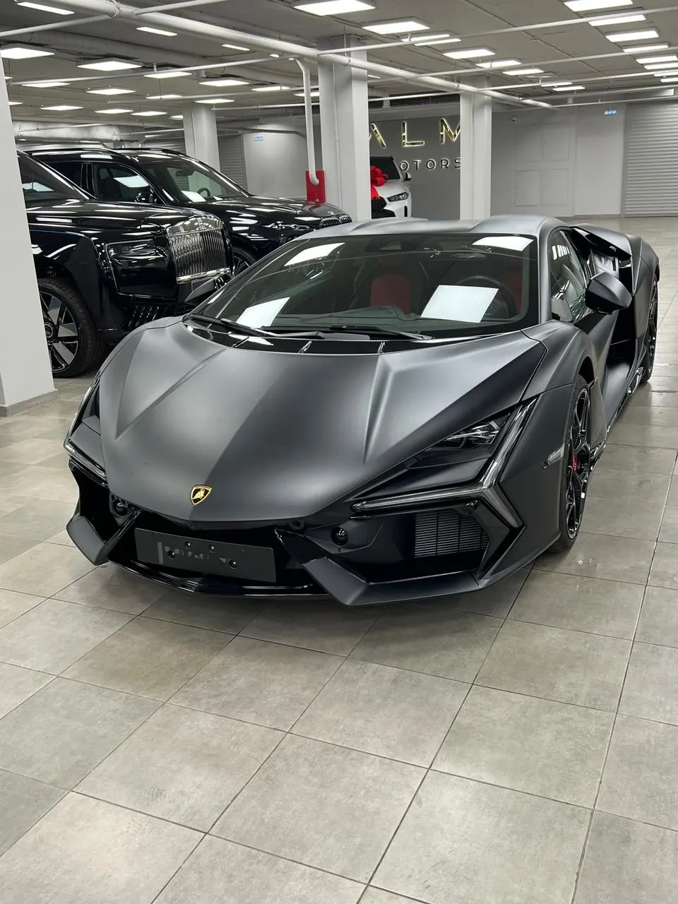 Grey Lamborghini Revuelto in a showroom